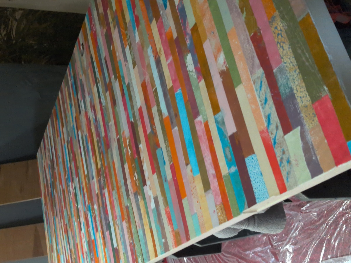 The completed collage surface, sitting on a pair of sawhorses in the theater.